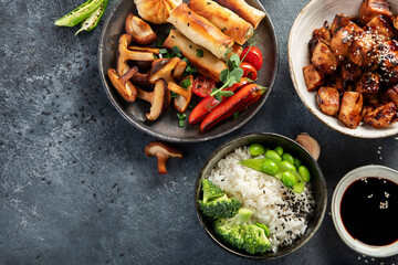 Homemade sesame Chicken served with white rice and vegetables. Asian food dishes.