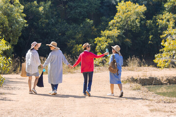 Group of Asian retirement women traveling, hiking, walking together in park, senior pensioner friends spend time exercise trekking outdoor, elderly tourist recreation relationship lifestyle day trip