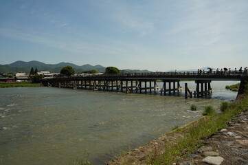 Fototapeta na wymiar Togetsukyo Bridge or Moon Crossing Bridge is at Arashiyama in Kyoto, Japan