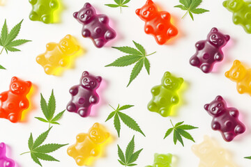 Colourful Gummy Bears with Cannabis Leaves Flat Lay.
Assorted colourful gummy bears arranged with fresh cannabis leaves on a white background.