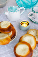 Homemade cheesecakes or curd patty made of cottage cheese on the table laid for cozy breakfast