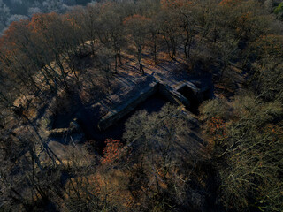 fly over ruins of castle where only cellars are visible in the sky. winter landscape at sunrise....