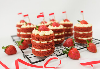 Mini red velvet cake with cream cheese and strawberry. Celebration of August 17, Indonesia's Independence Day. Selective focus.