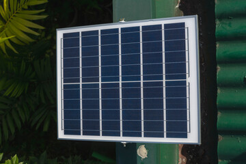 A small 50 watt Polycrystalline solar panel mounted on the edge of the roof of a house for an off-grid light.