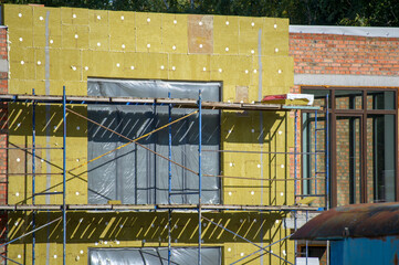 view of construction doing insulation of wall at construction site