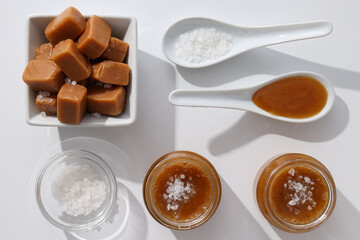 Cubes of salted caramel with caramel in a jar