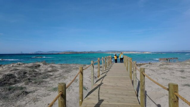 Walking on a Wooden Boardwalk to Crystal Clear Sea in Formentera
