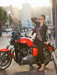 Bike, fashion and woman in city with sunglasses for travel, transport or road trip as rebel....