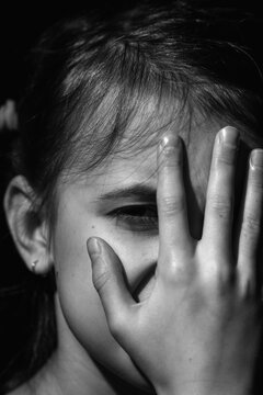 Pain and loneliness concept. Black and white image of crying chld girl.