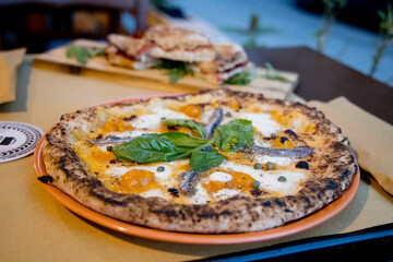 Experience street food by tasting freshly baked pizza made in Naples in multiple flavors and various types