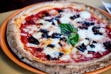 Experience street food by tasting freshly baked pizza made in Naples in multiple flavors and various types