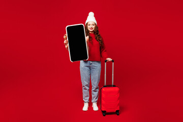 Traveler woman wear sweater hat casual clothes hold bag blank screen mobile cell phone isolated on...