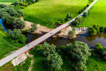 View from a drone of a road bridge over the river with cars driving along it