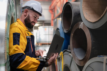 Industrial engineer in safety helmet uniform jacket working in heavy steel engineering factory....
