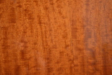 Unusual lacquered wooden background, lacquered furniture with dark and brown patterns, stains.