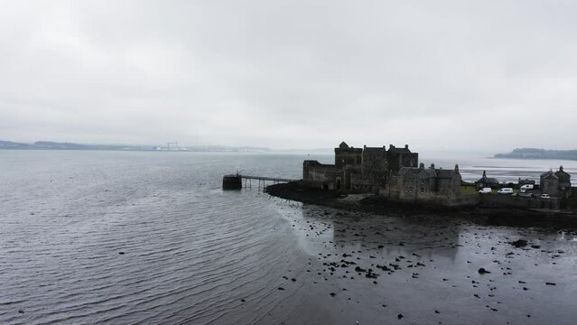 Aerial shot pushing towards the infamous Blackness Castle in Scotland.