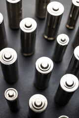 Batteries arranged side by side, on a dark surface. Batteries, energy and respect for the...