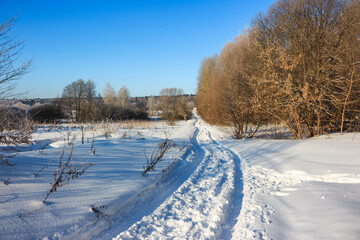 Uncleared snow-covered road in the countryside