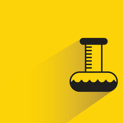 science flask with shadow on yellow background
