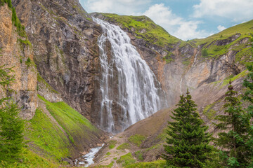 Waterfall in the mountains. Upper Engstligen Waterfall, Bernese Oberland, Switzerland. The beauty of the Engstligen waterfall put it on the Swiss Inventory of Landscapes of National Importance.