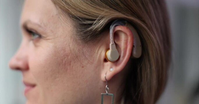 Woman wearing hearing aid on ear