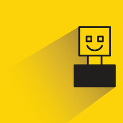 smile robot with shadow on yellow background