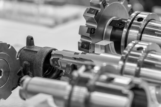 Detailed black and white photograph captures the complex interplay of metal gears and components, showcasing the beauty of precision engineering.