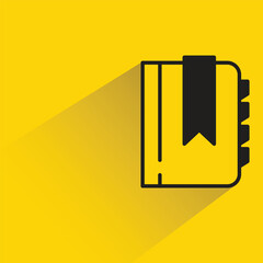 book icon with shadow on yellow background