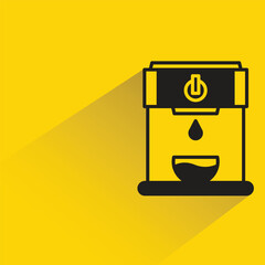 coffee machine with shadow on yellow background