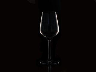 wine drinks  glass silhouette against a black background with copy space