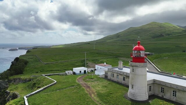 Drone fly over Albarnaz Lighthouse on sunny day in Flores Island, azores archipelago