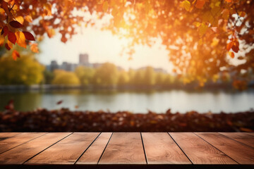 Naklejka na ściany i meble Empty blank wooden table fall background with autumn trees orange yellow color leaves backdrop forest or park nature scene abstract blurred bokeh tabletop for product display desk mockup. Copy space .