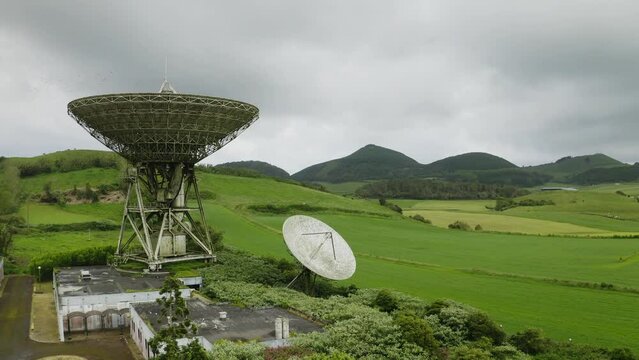 Drone fly over parabolic antenna radio station on cloudy day in Sao Miguel Island, Azores