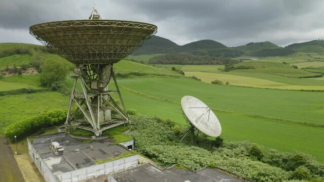 Drone fly over parabolic antenna radio station on cloudy day in Sao Miguel Island, Azores