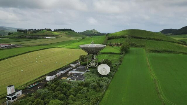 Drone fly over parabolic antenna radio station on cloudy day in Sao Miguel Island, Azores