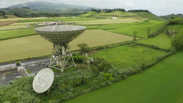 Drone fly over parabolic antenna radio station on cloudy day in Sao Miguel Island, Azores