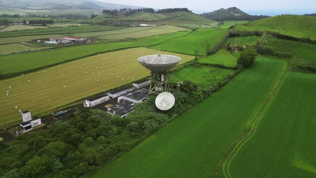 Drone fly over parabolic antenna radio station on cloudy day in Sao Miguel Island, Azores