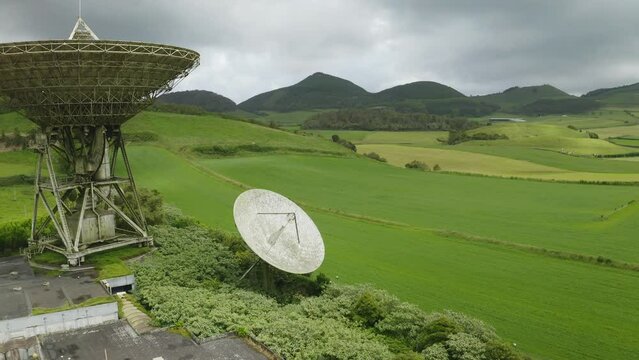 Drone fly over parabolic antenna radio station on cloudy day in Sao Miguel Island, Azores