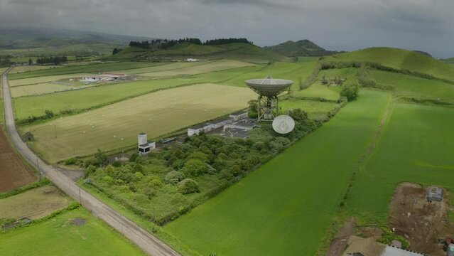 Drone fly over parabolic antenna radio station on cloudy day in Sao Miguel Island, Azores