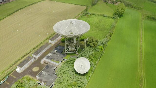 Drone fly over parabolic antenna radio station on cloudy day in Sao Miguel Island, Azores