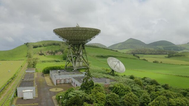 Drone fly over parabolic antenna radio station on cloudy day in Sao Miguel Island, Azores