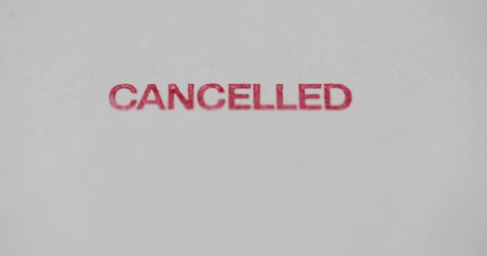 Person poses canceled stamp in closeup. Cancel message denied and blocked concept
