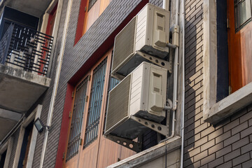 Naklejka premium Air conditioner outdoor unit heat condenser coils fan cooling use R32 exchange gas liquid at Asian city building