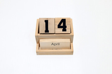 14th of April wooden perpetual calendar. Shot close up isolated on a white background