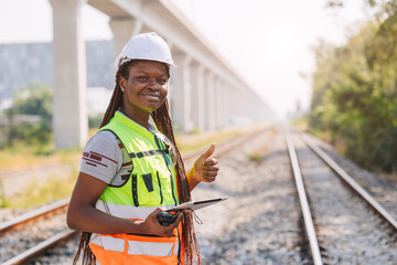 Portrait African black engineer women worker work checking service in train railway tracks...