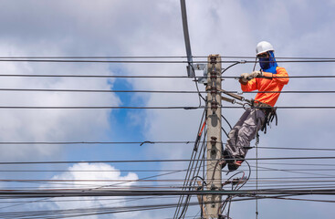 Electrician with Safety equipment and various work tools Installing Cable lines and Electrical...