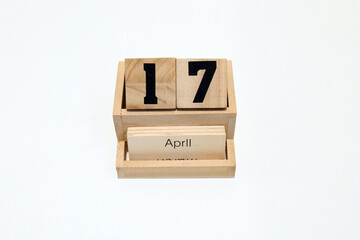17th of April wooden perpetual calendar. Shot close up isolated on a white background