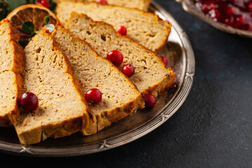 Delicious chicken and pork pate in Christmas decoration. Rustic style. Dark background, metal plates. Front view.