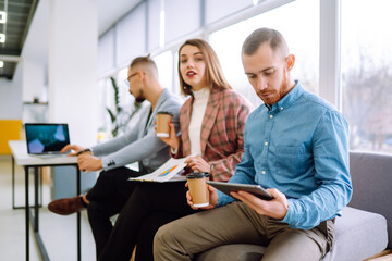 Obraz premium Office work. Young entrepreneurs collaborating on a new project in a Modern Bright Office. Planning, business, study, collaborate work in teamwork.