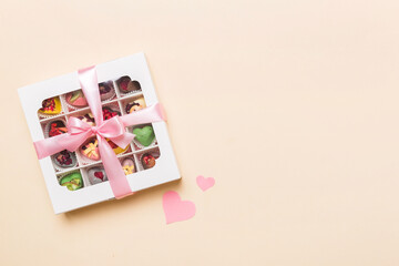 Valentine day composition: sweet candy, with gift boxes with bow and red felt hearts, photo template, background. Top View with copy space
